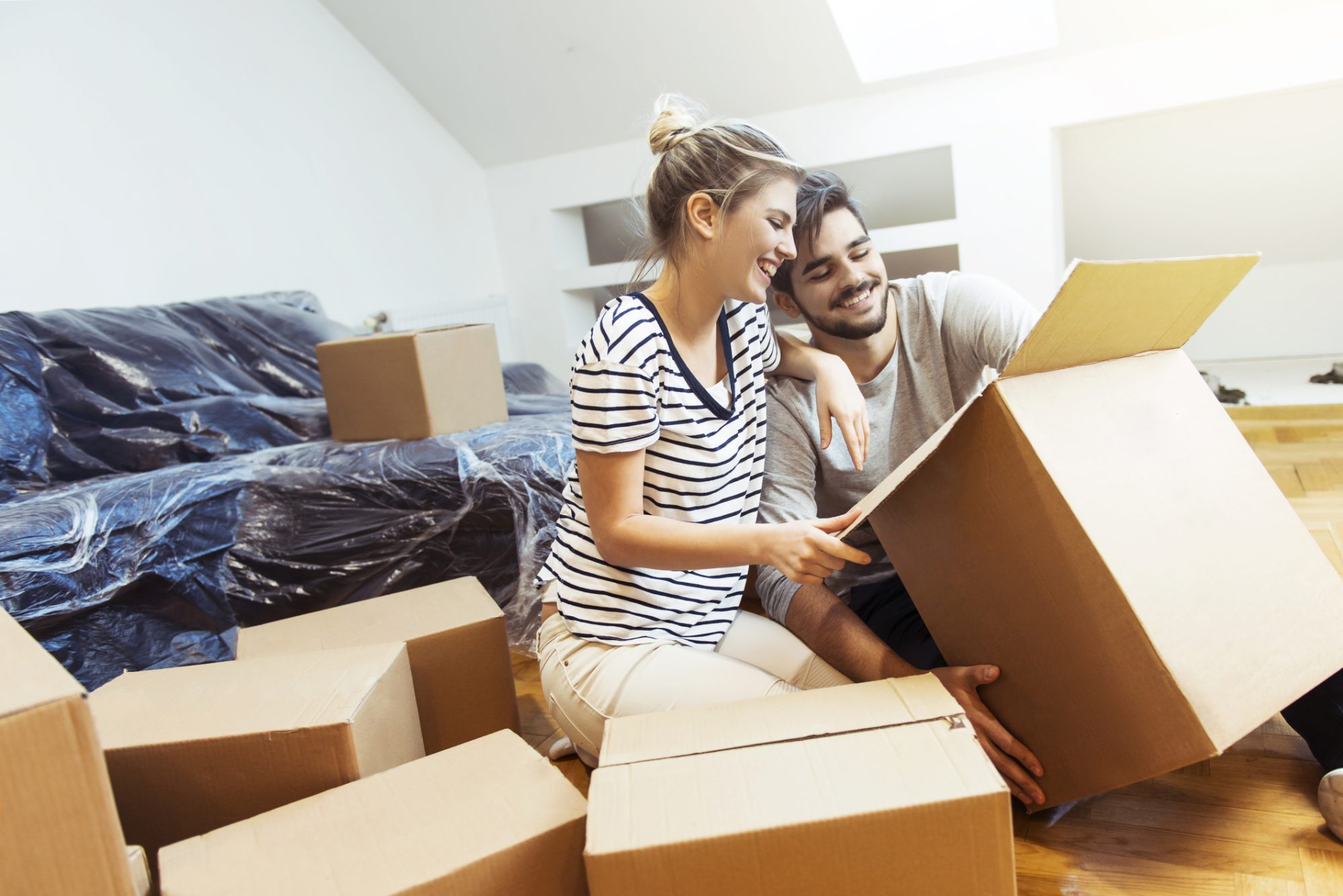 Young couple moving into their new home, boxes